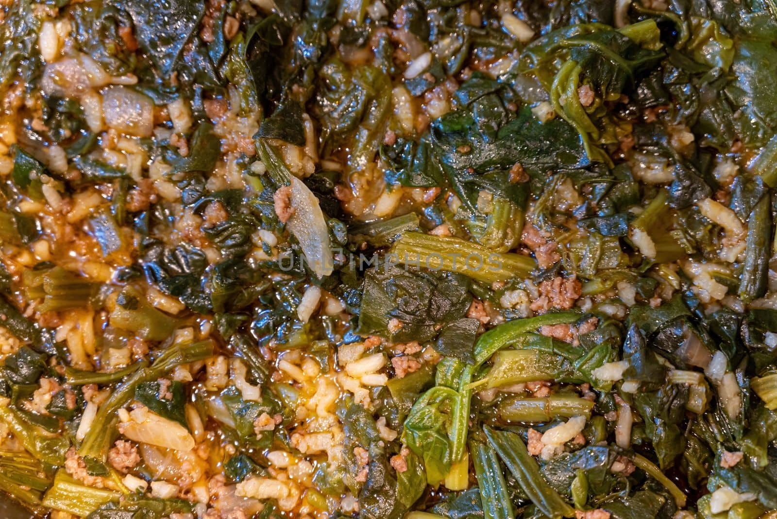 Traditional Turkish spinach meal with rice and minced meat with yogurt on a white porcelain plate by Sonat