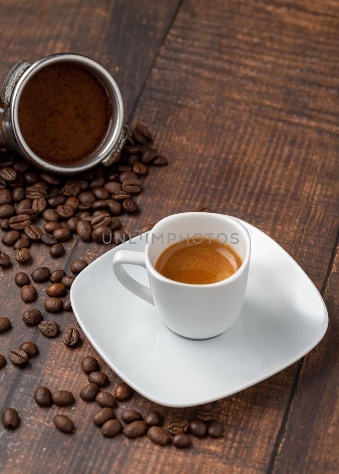 Fresh espresso coffee together decorated with coffee beans on wooden table by Sonat