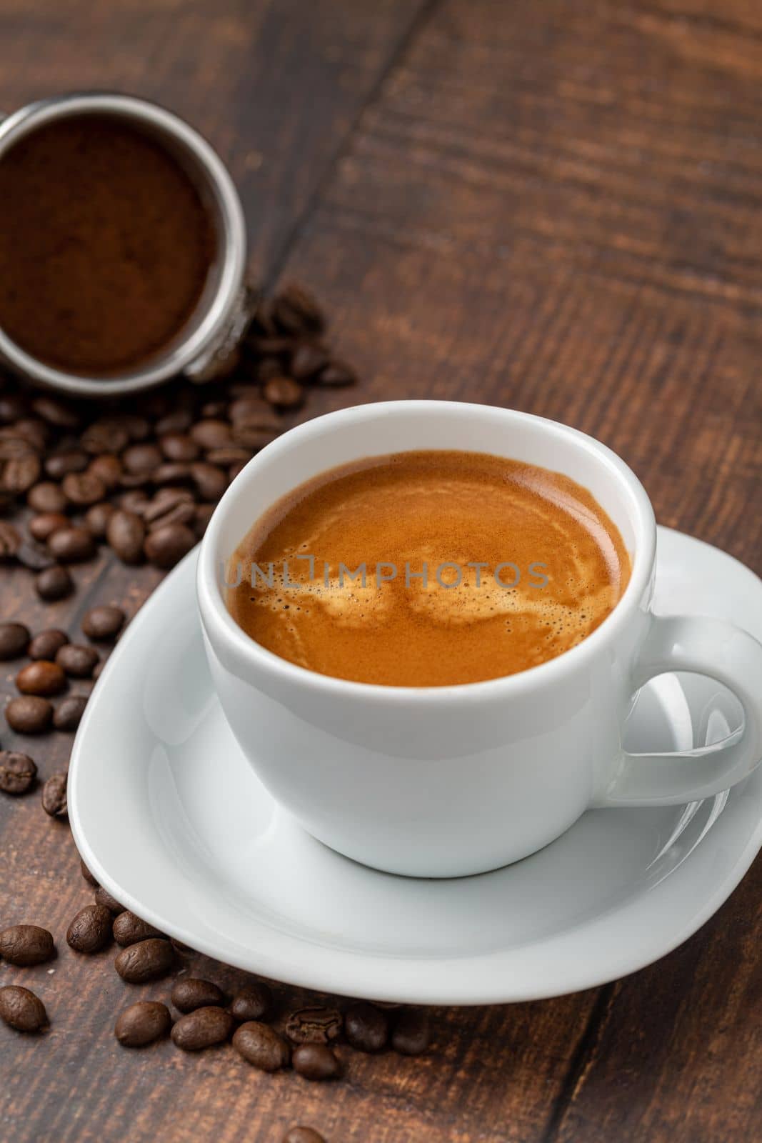 Fresh double espresso coffee and coffee beans on wooden table