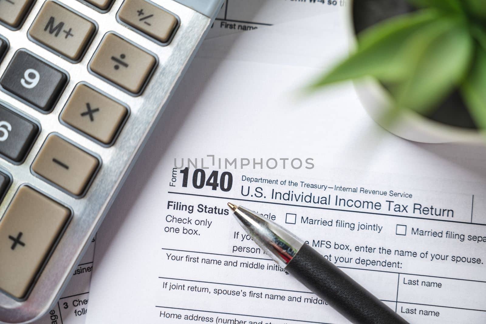 Financial time tax return forms with pen and calculator by Sonat