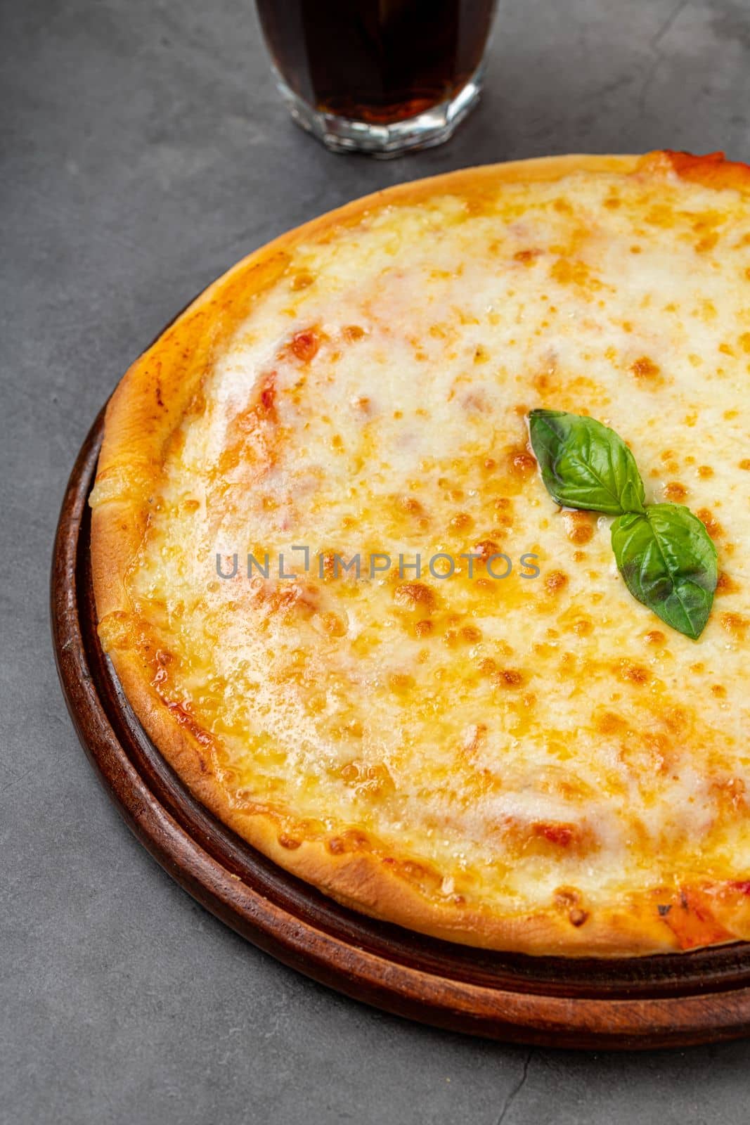 Italian pizza with four cheeses and lots of mozzarella on a cutting board