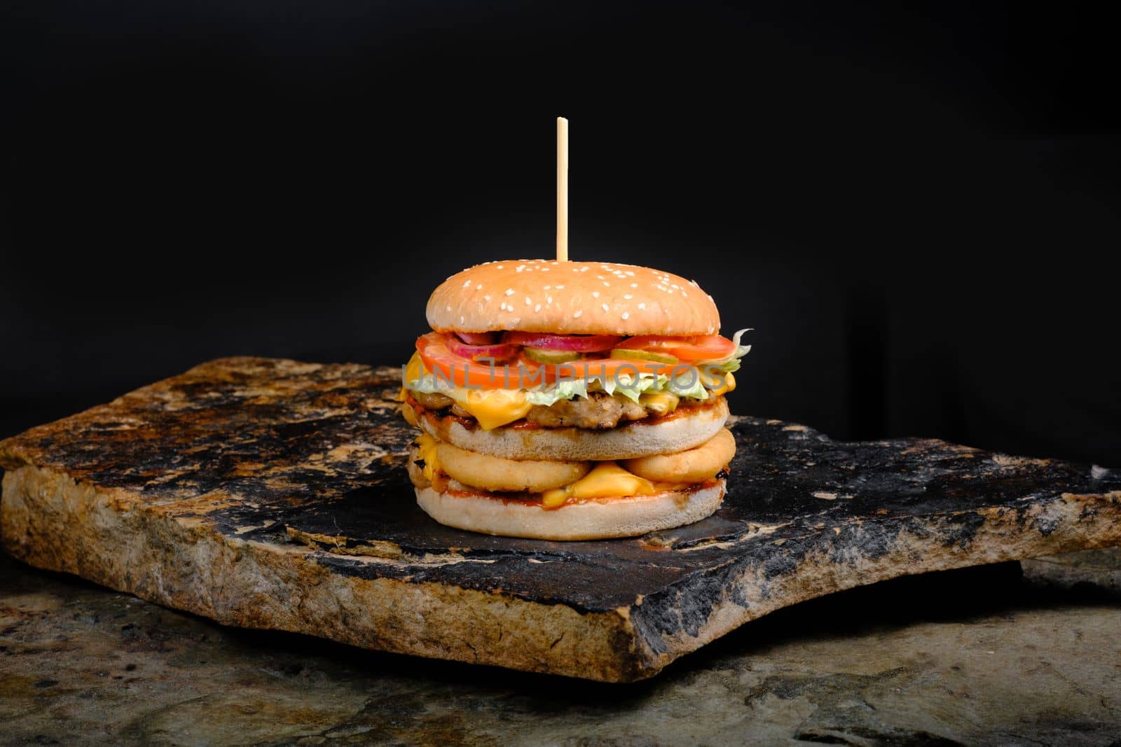 Rustic tasty Burger on Stone Background by Symonenko
