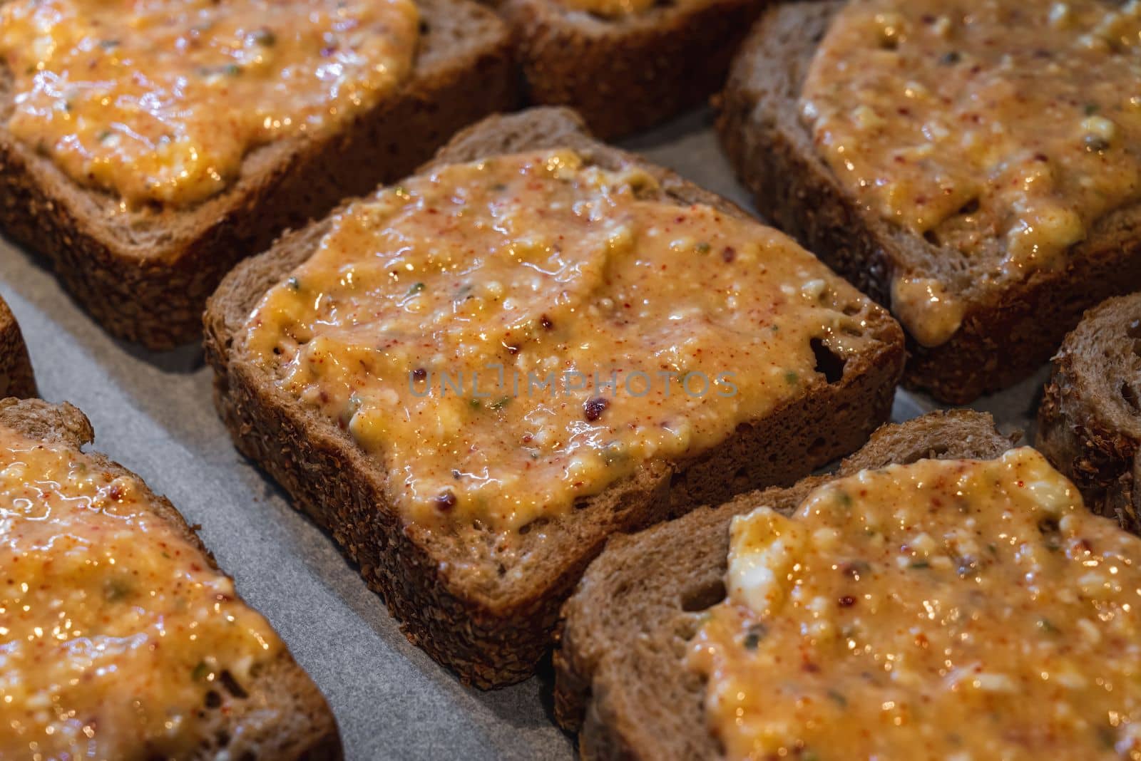 Slices of toasted bread covered with a mixture of egg and feta cheese