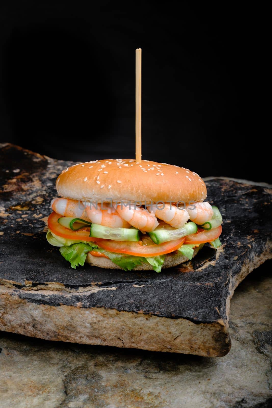 Rustic tasty Burger on Stone Background dark