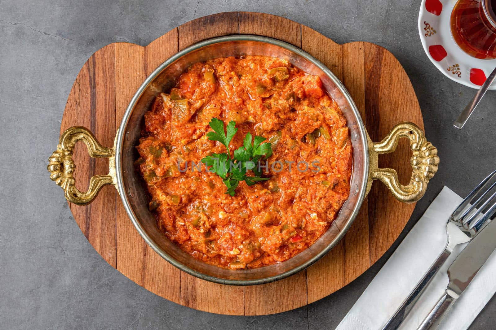 Turkish traditional menemen dish made with eggs, onions, peppers and tomatoes by Sonat