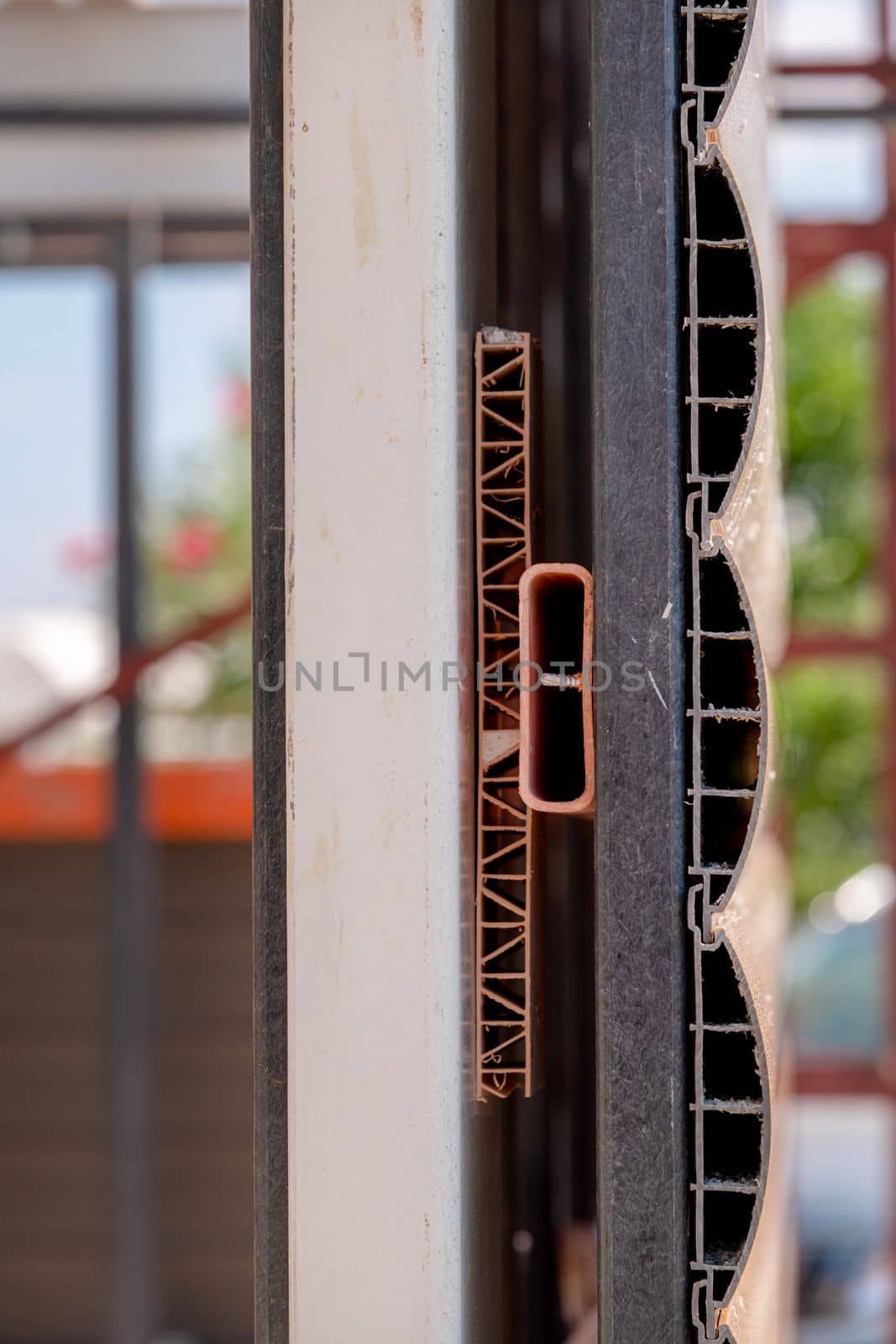 Facade cladding screwed into an iron profile to cover the exterior of a building