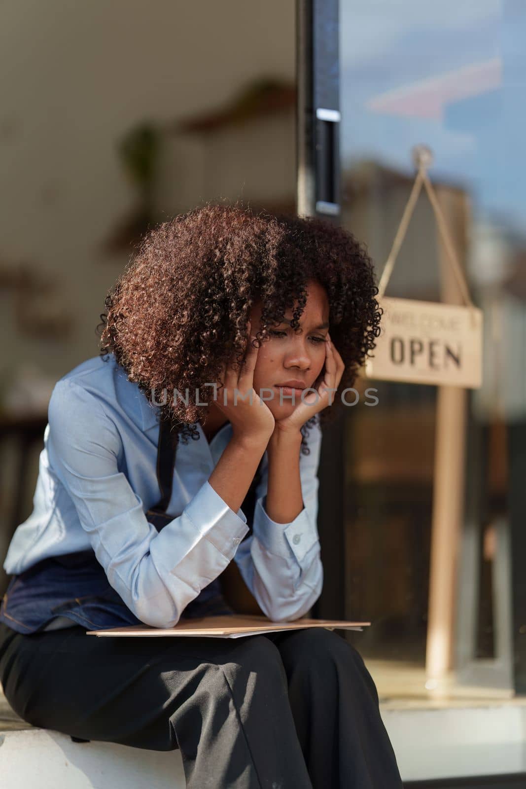 Stressed American African black woman at cafe. Small business concept.