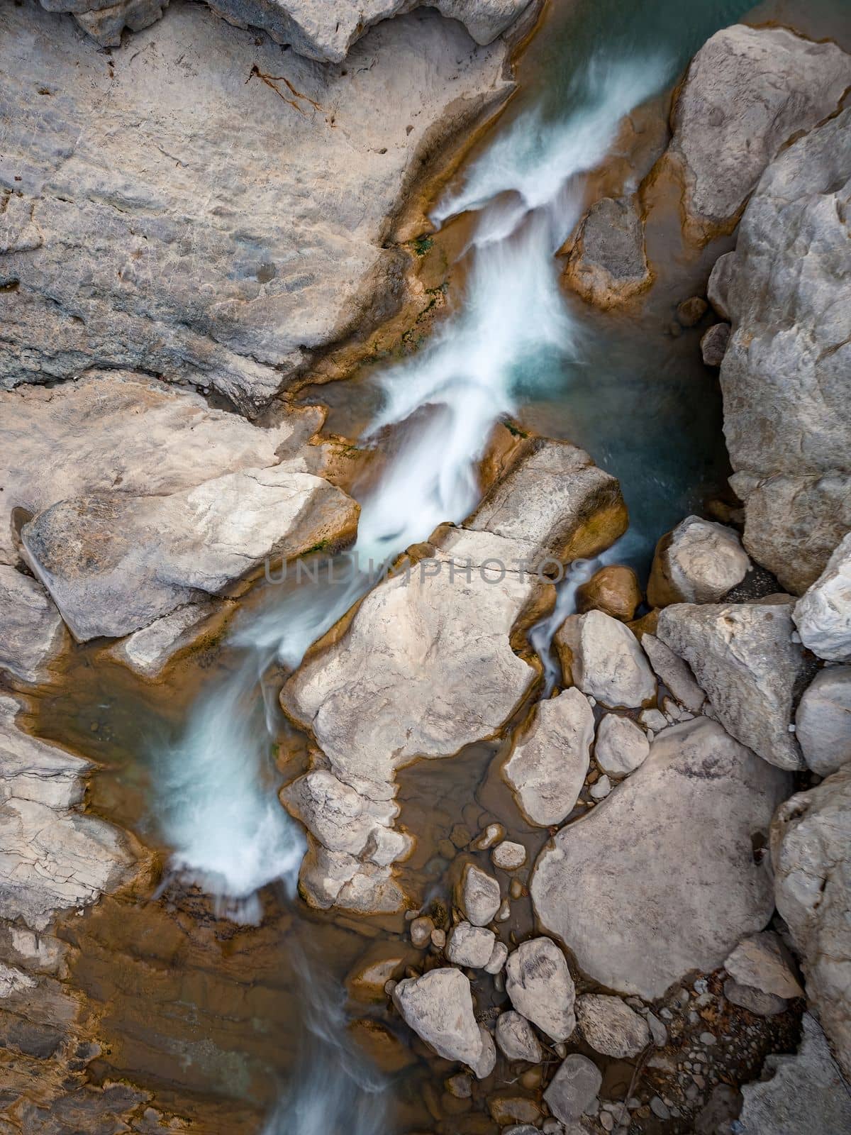 River flowing between rocks with motion blur shot with long exposure technique by Sonat