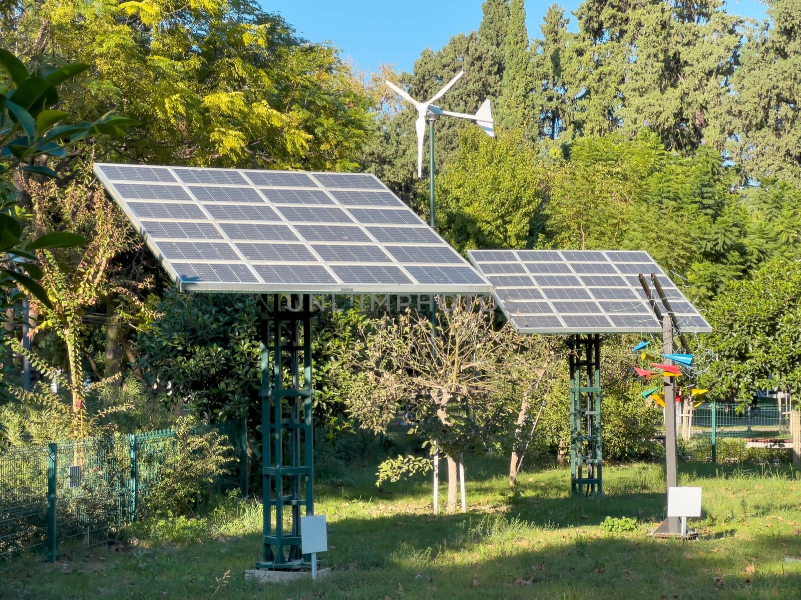 Wind turbine and solar panel installed in the green park area