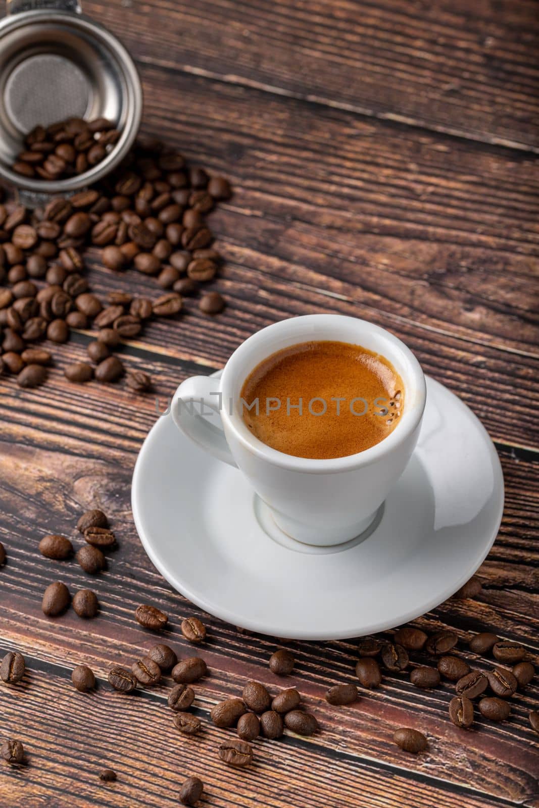 Fresh espresso coffee together decorated with coffee beans on wooden table