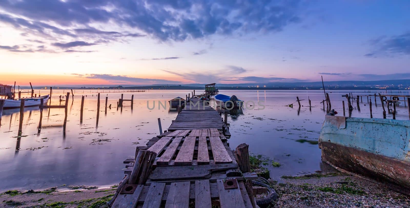 exciting panoramic landscape on a lake with a wooden pier and boats