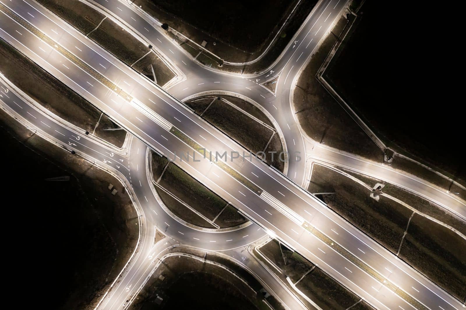 Aerial view of urban highway intersection road in the night light.