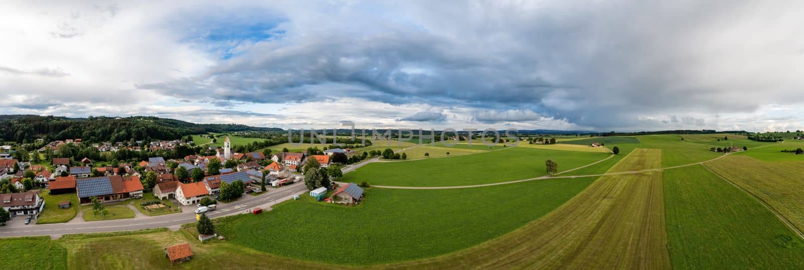 Stunning panoramic view of a small village green countryside and cloudy sky in Germany