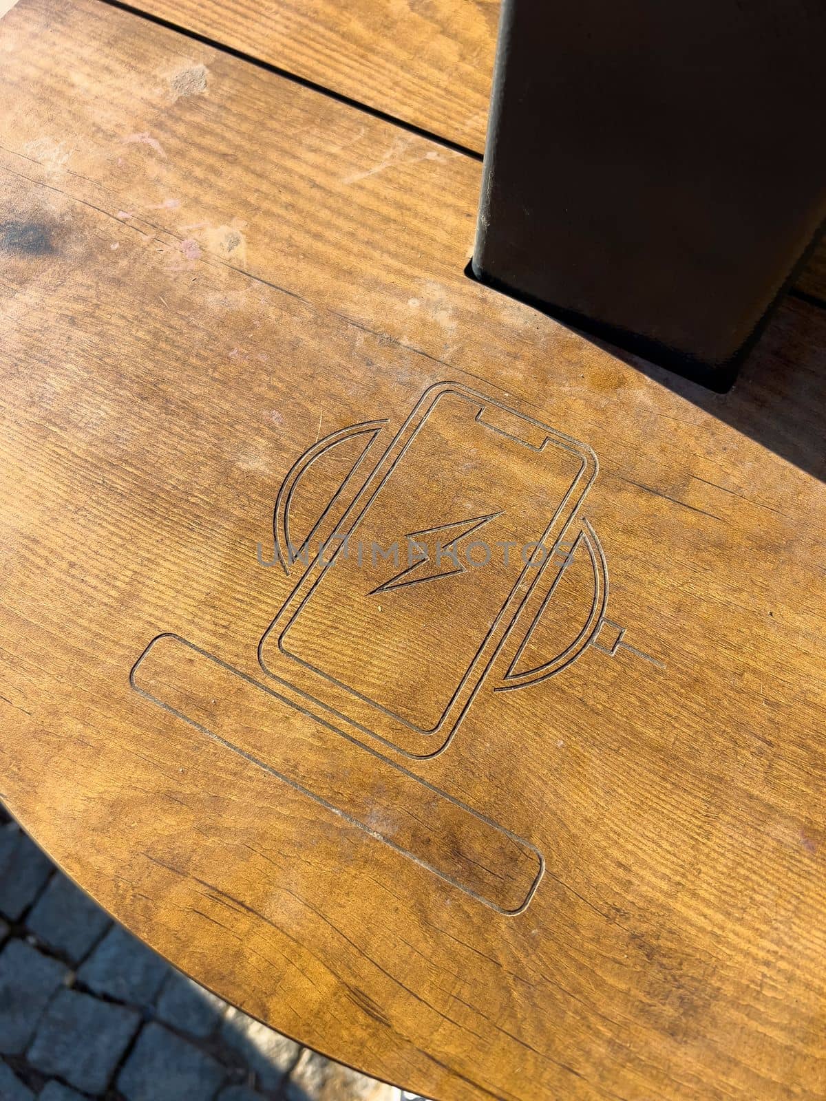 Public wireless smartphone station on wooden table