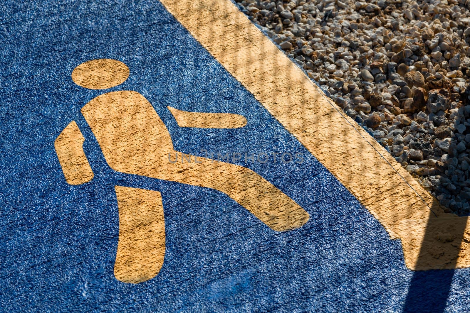 running sign, yellow running sign on a blue background on a jogging track by Sonat