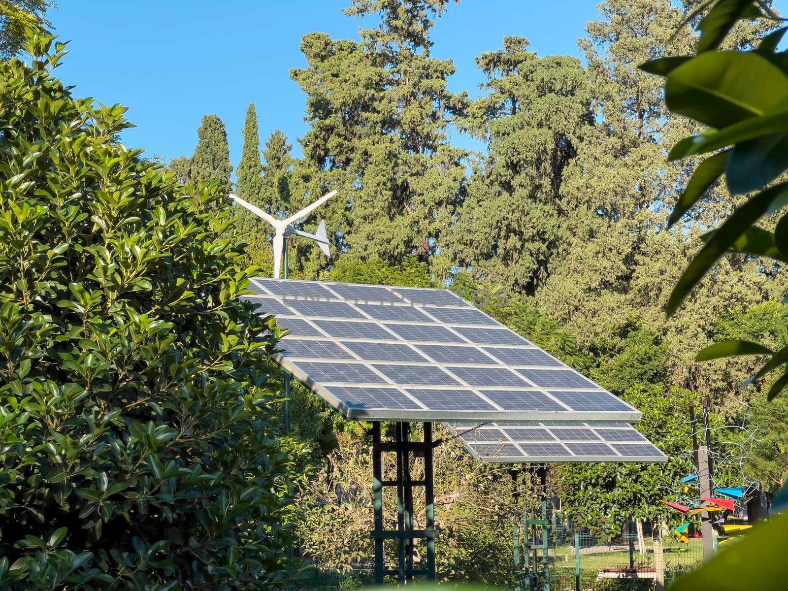 Wind turbine and solar panel installed in the green park area by Sonat