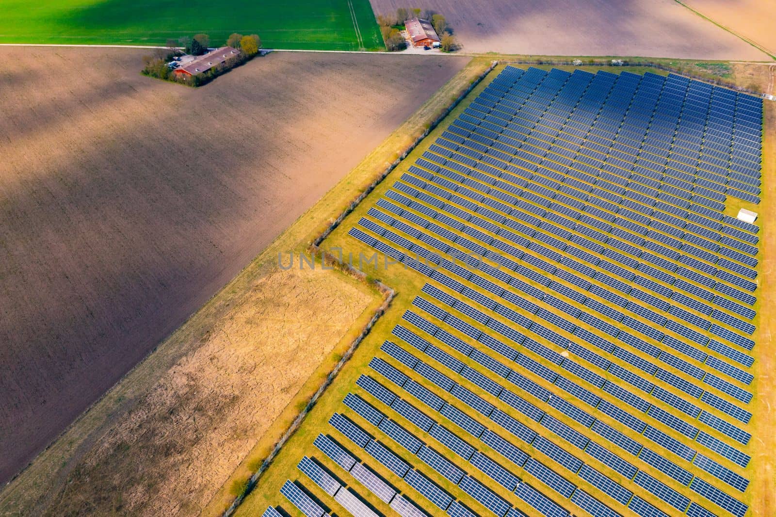 Agriculture and fields next to solar panels of a solar park in rural Germany