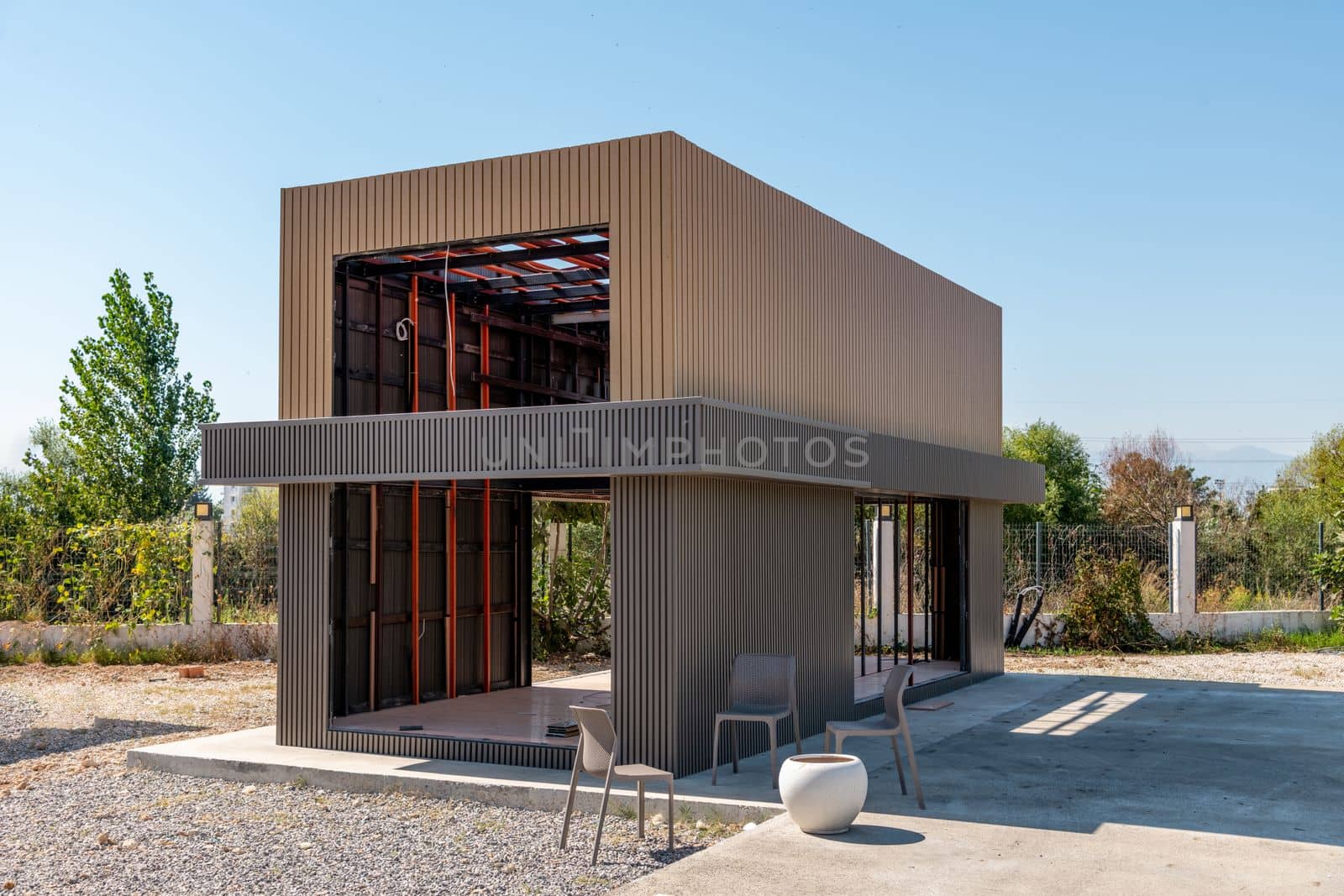 Newly built metal framed building with siding. Construction of a new tiny house. selective focus by Sonat
