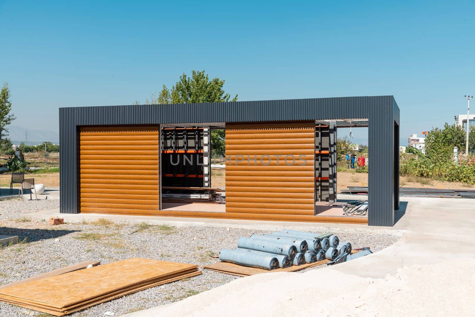 Newly built metal framed building with siding. Construction of a new tiny house. selective focus by Sonat