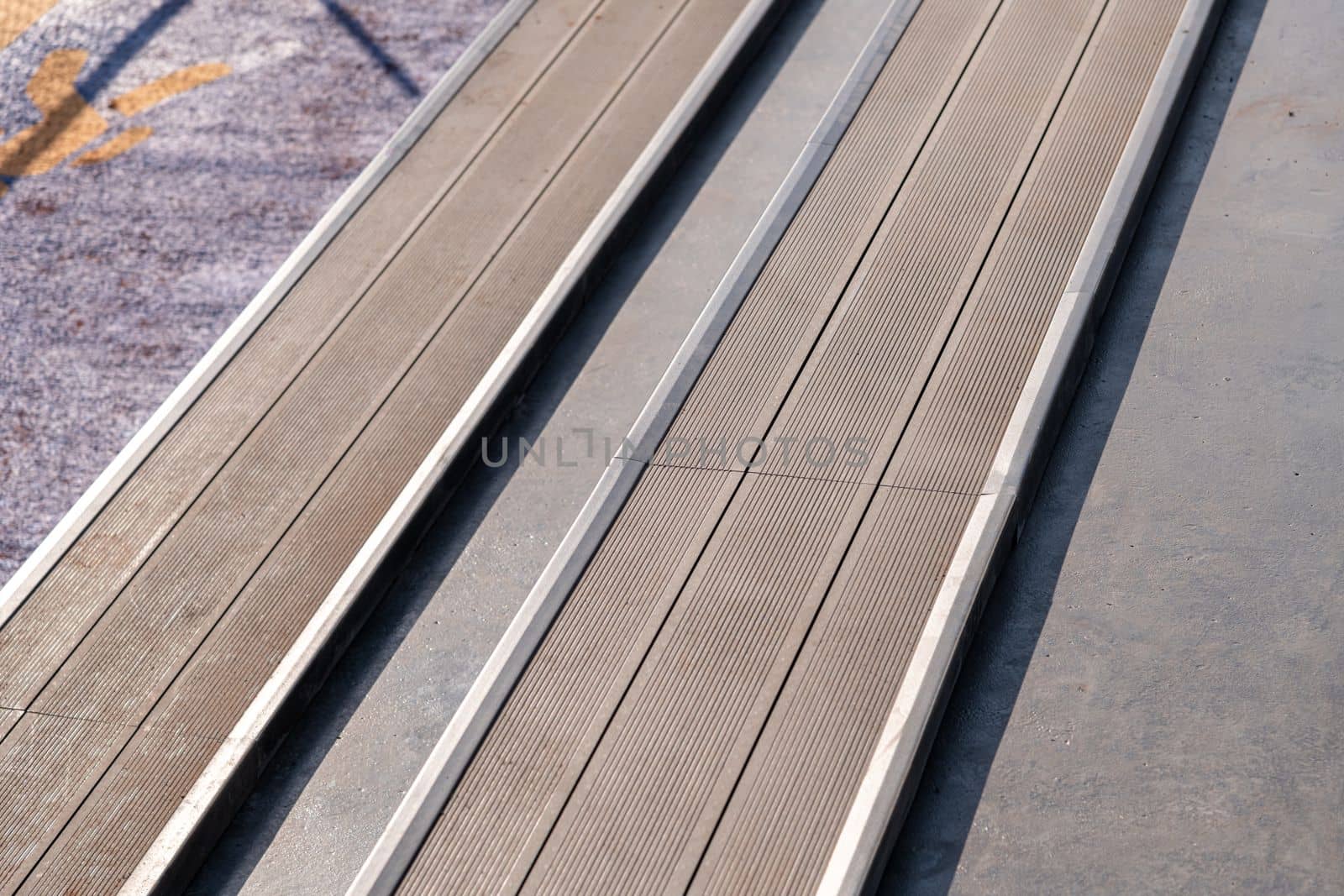 Seating area for spectators made with composite deck next to the tennis court