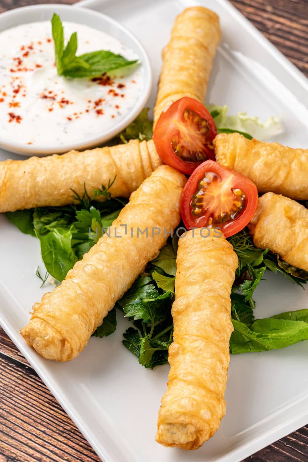Turkish Cigar Shaped Rolls on a white porcelain plate. The Turkish name is Sigara Boregi