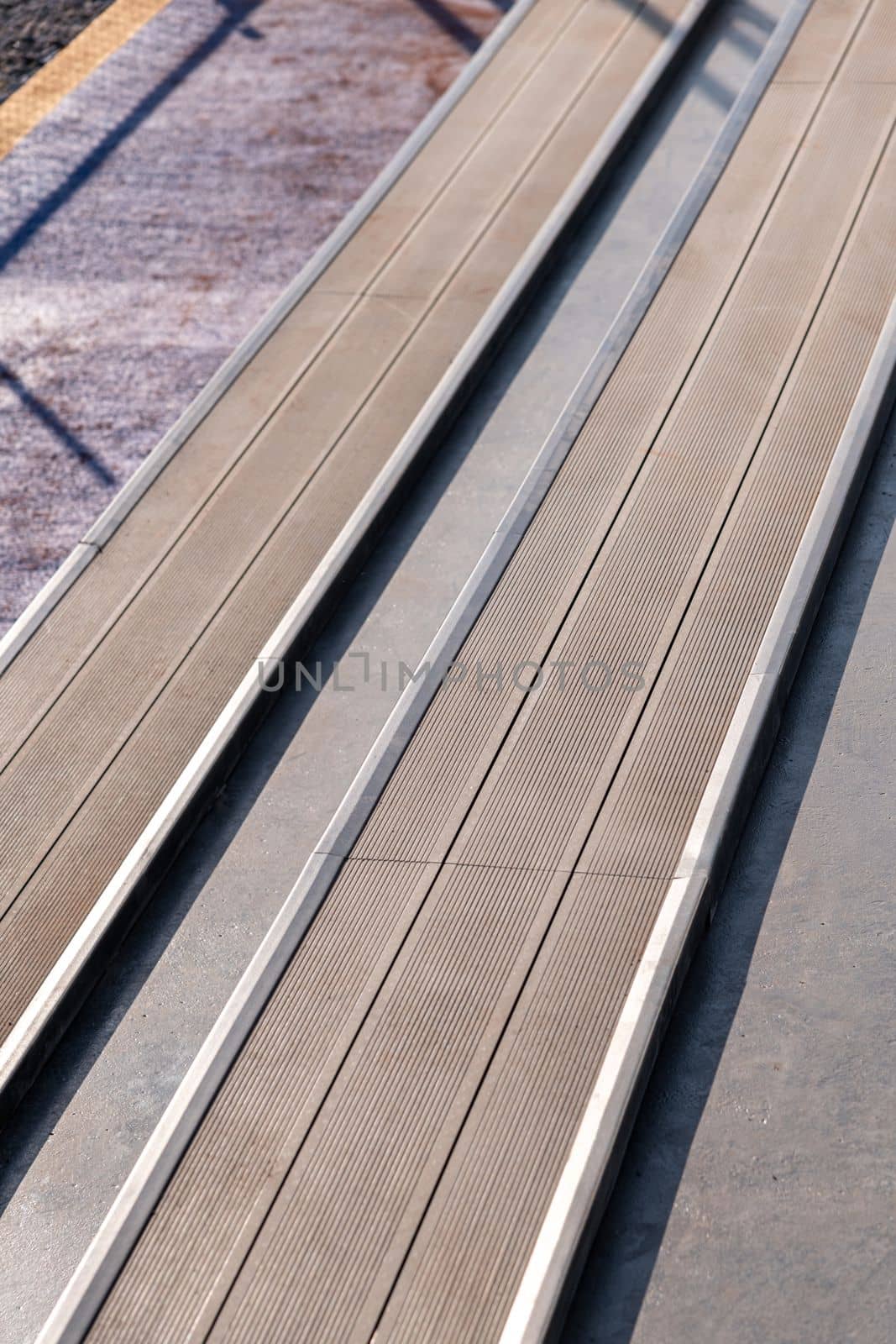 Seating area for spectators made with composite deck next to the tennis court