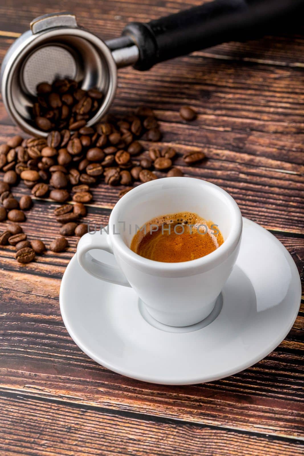 Fresh espresso coffee together decorated with coffee beans on wooden table