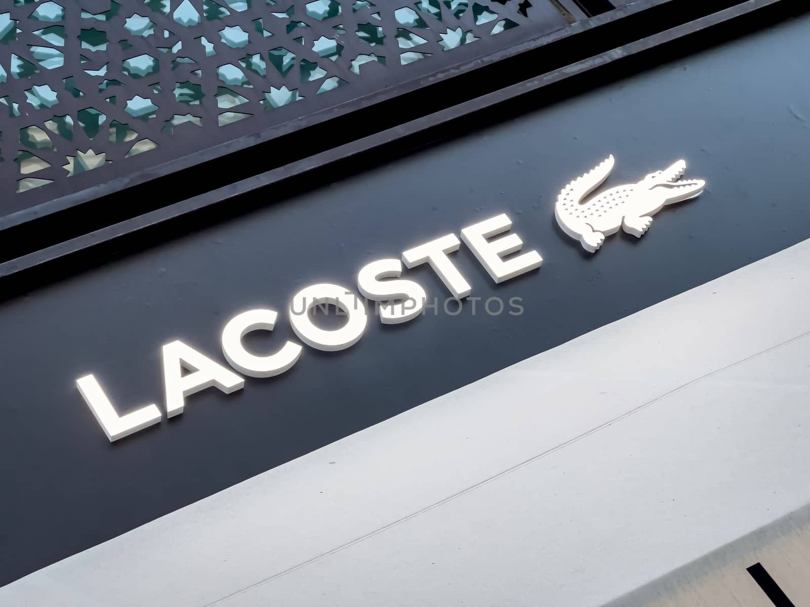 Antalya, Turkey - November 29, 2022: Illuminated logo of Lacoste store in Antalya Turkey