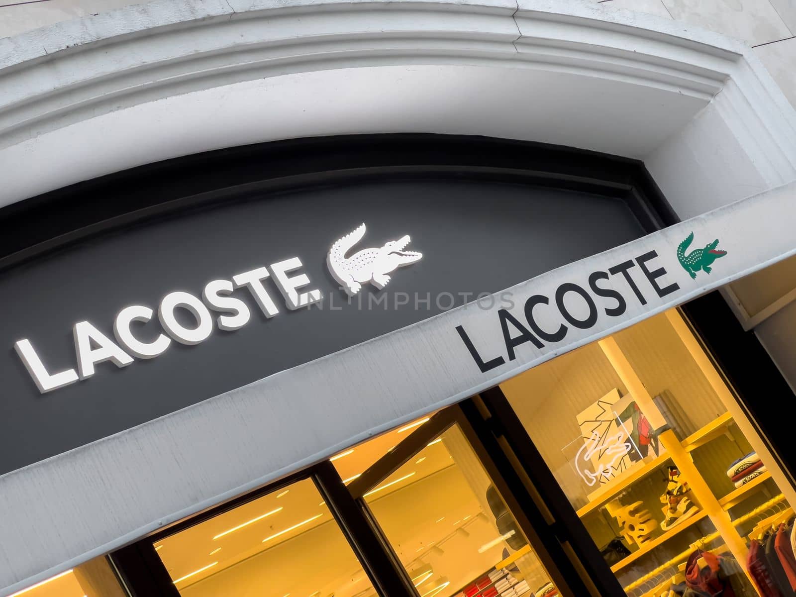 Antalya, Turkey - November 29, 2022: Illuminated logo of Lacoste store in Antalya Turkey