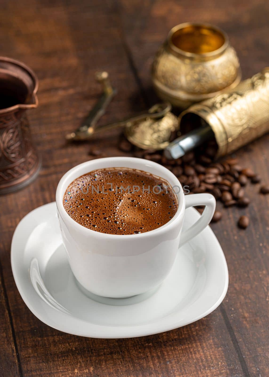 Turkish coffee in classic coffee cup with water and Turkish delight on wooden table by Sonat