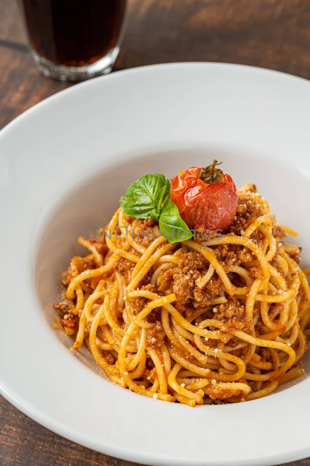 Spaghetti with bolognese sauce on a white porcelain plate