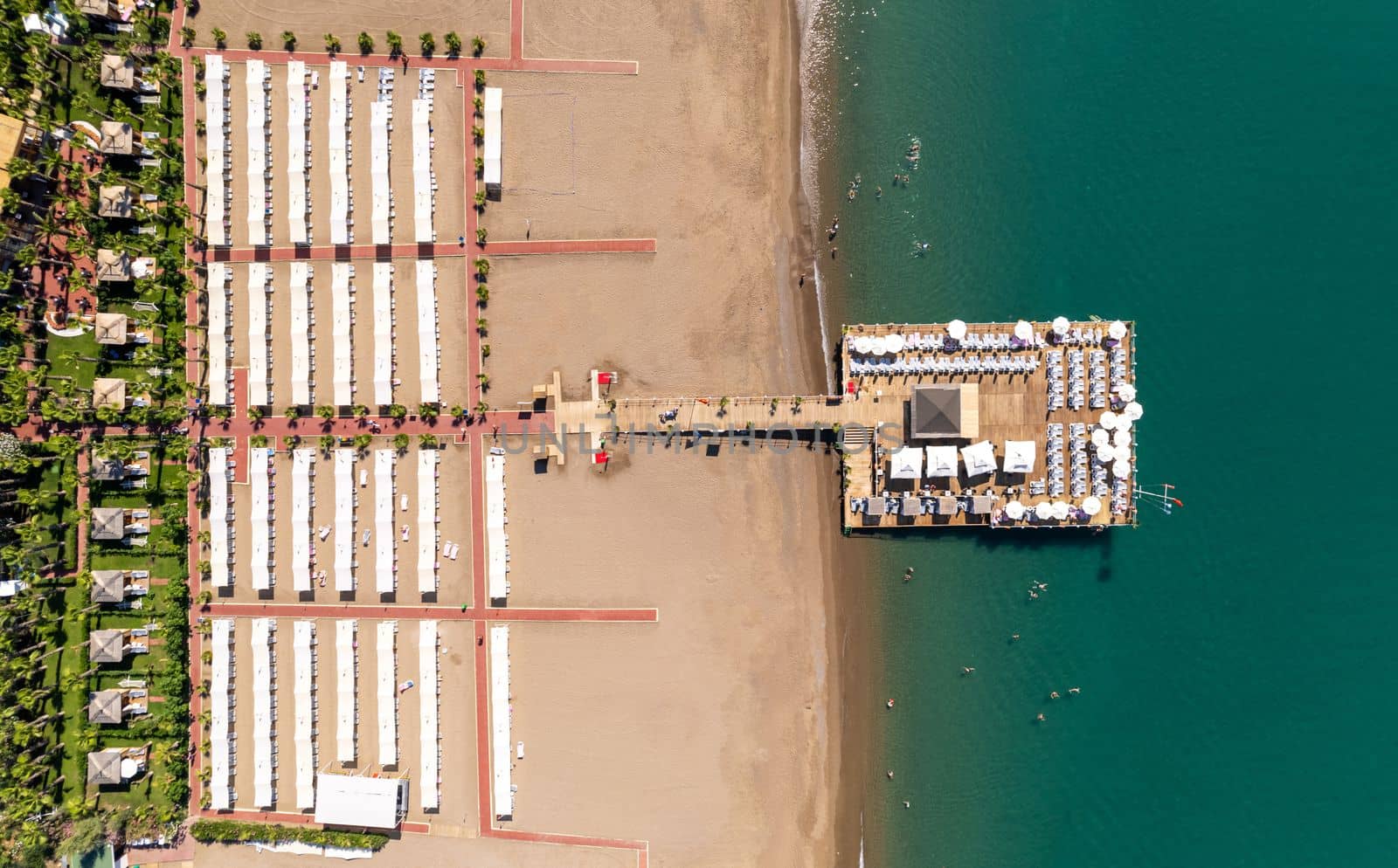 Aerial drone photo of hotel beach and pier on a sunny day