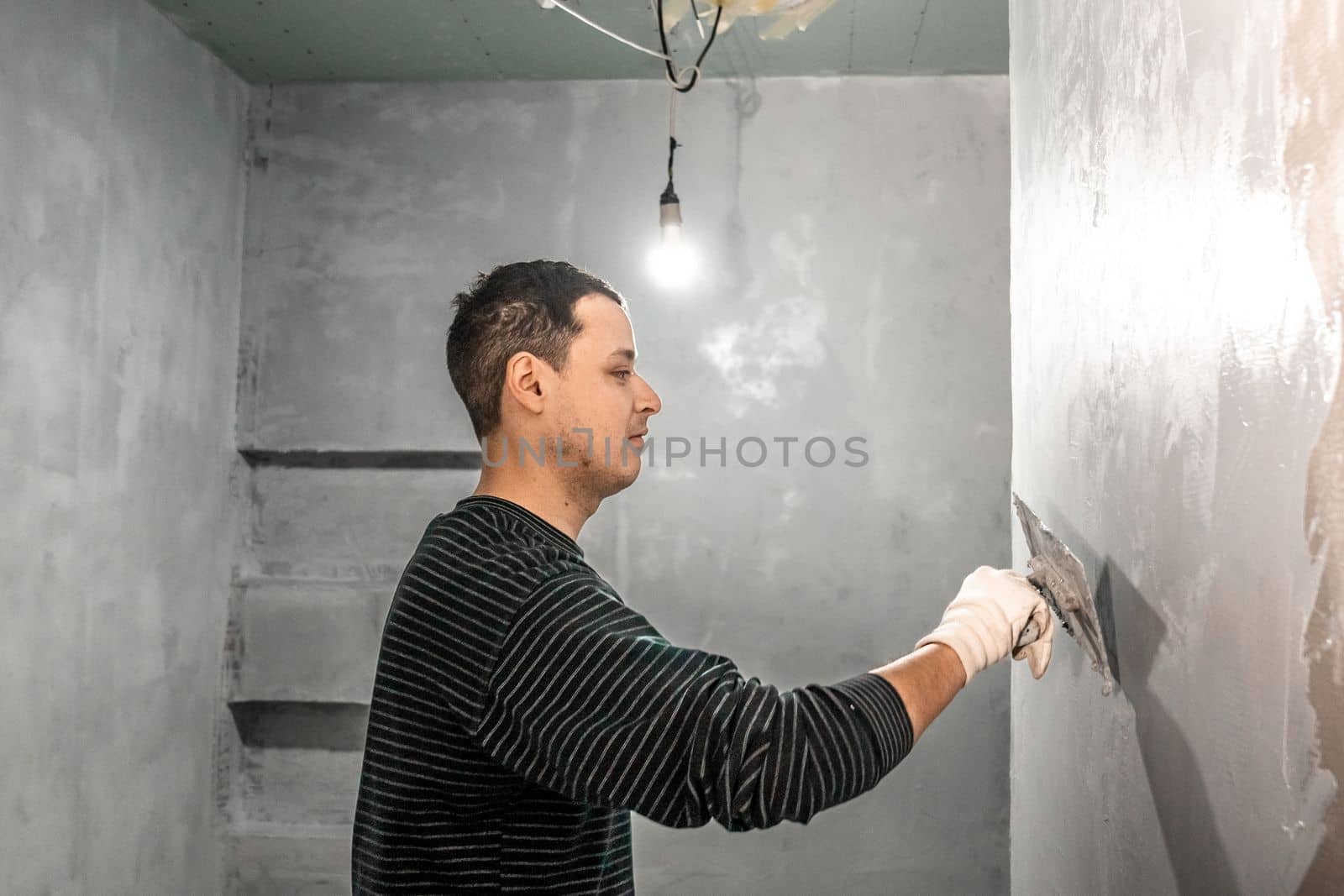 manual adjustment of the wall on the construction site with trowel. High quality photo