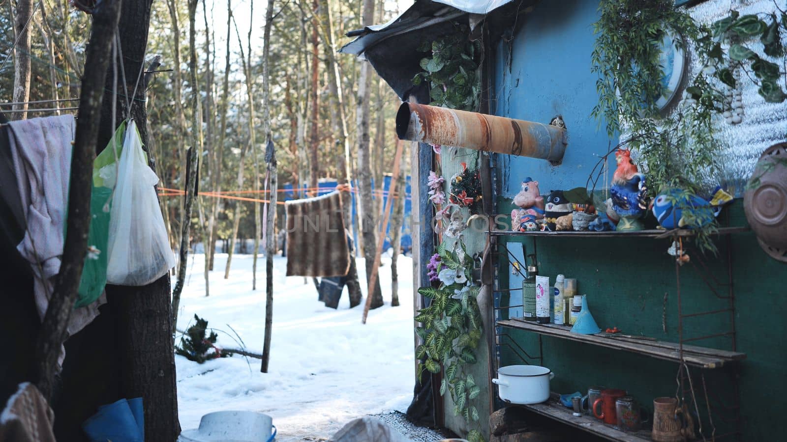 Homeless people go into their huts in the winter in the woods. by DovidPro
