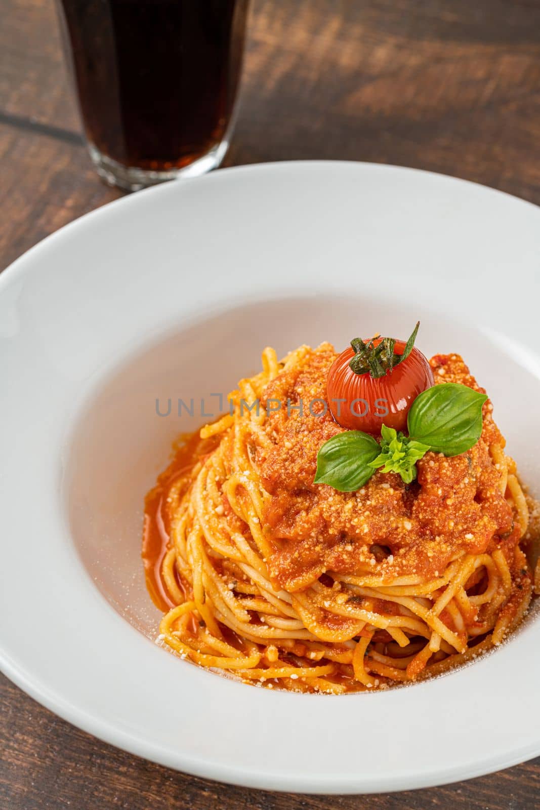 Pasta with cheese and tomato sauce on a white porcelain plate