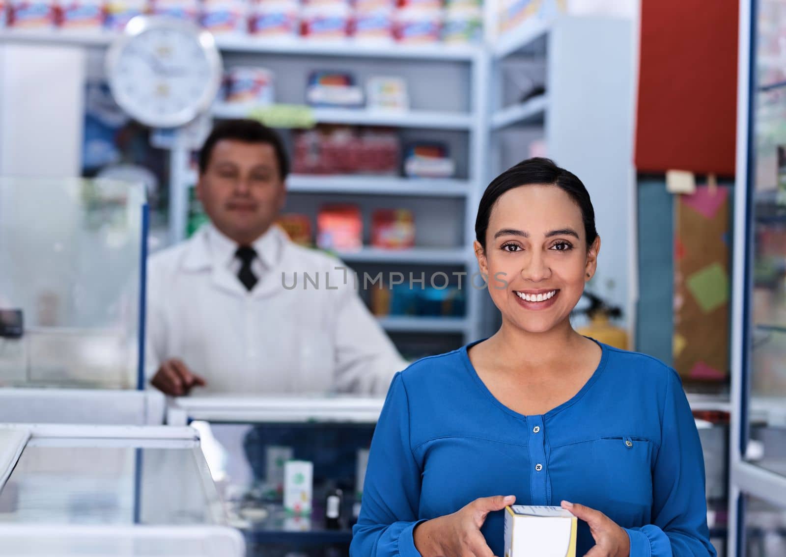 Ive got my medication, now to get better. a male pharmacist and female customer in a pharmacy. by YuriArcurs