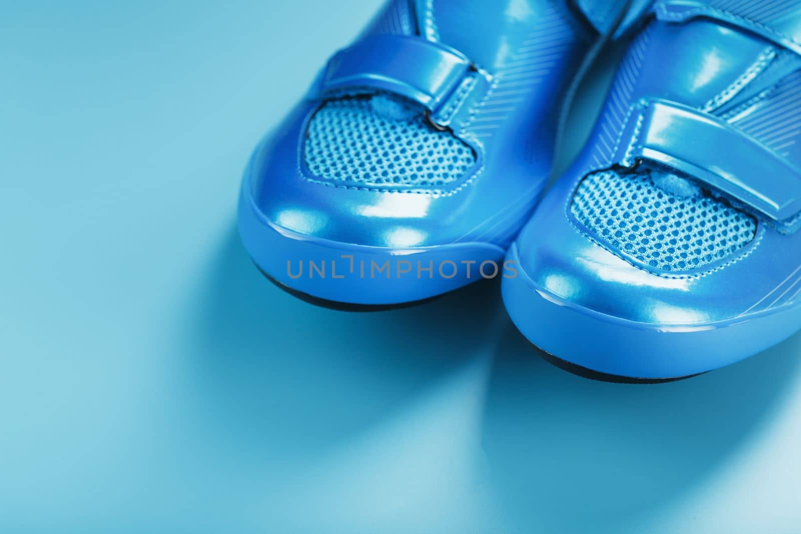 Blue bicycle shoes on a blue background by AlexGrec