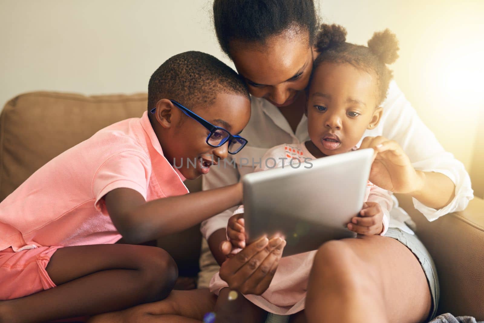 Family browsing. an affectionate young family using a tablet together at home