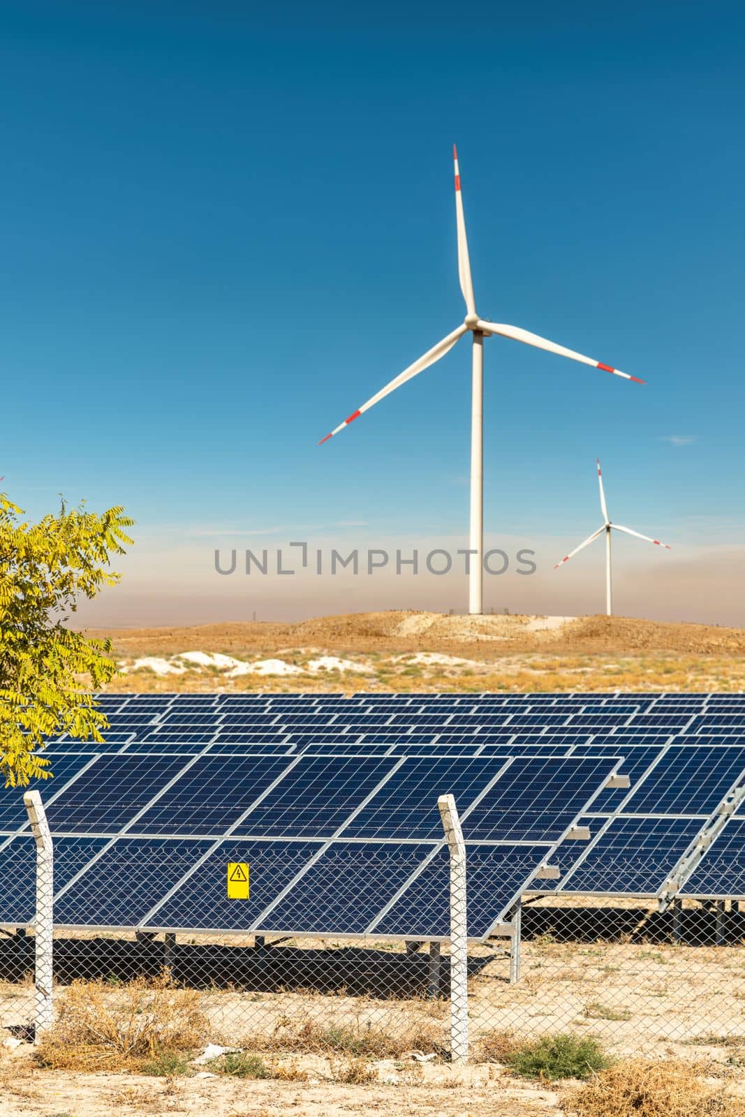 Solar photovoltaic panels and wind turbines. Green energy environmental concept by Sonat