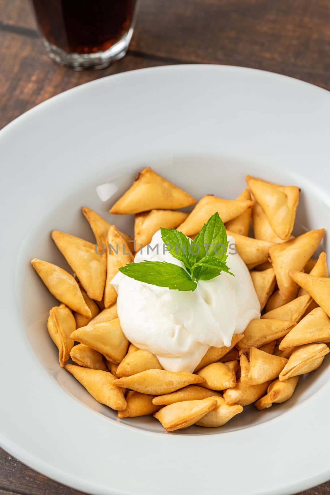 Deep fried crunchy Turkish ravioli or manti on a white porcelain plate