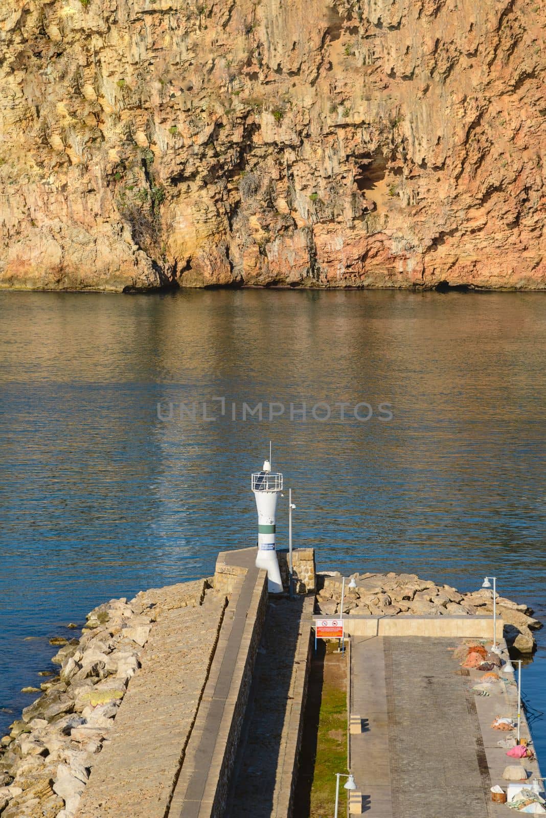 The view of the breakwater and the lighthouse at the Old Antalya Marina in Kaleici by Sonat
