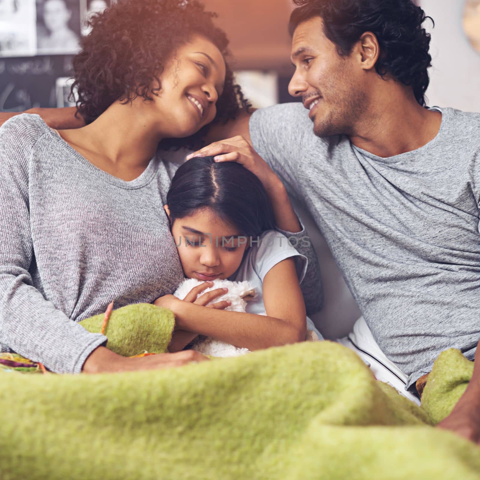 Spending quality time together. a happy family sitting together on the sofa at home