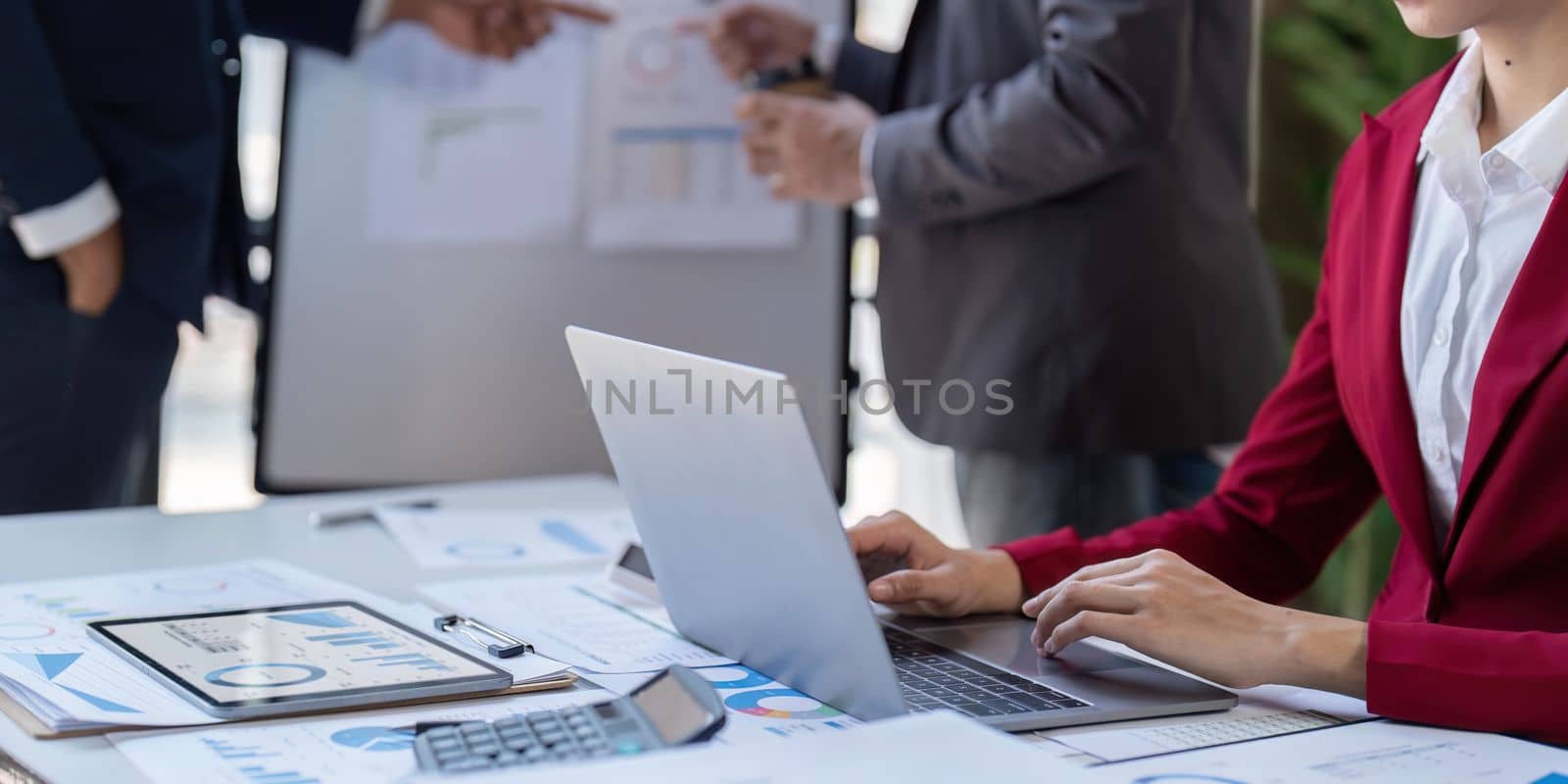 Team of business investment consultant analyzing company annual financial report working with documents pie and donut chart, using laptop and tablet, Business and Financial concept.
