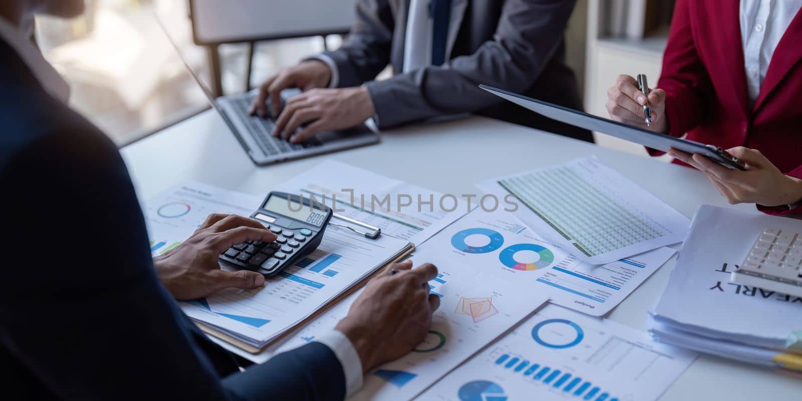 Team of business investment consultant analyzing company annual financial report working with documents pie and donut chart, using laptop, Business and Financial concept.