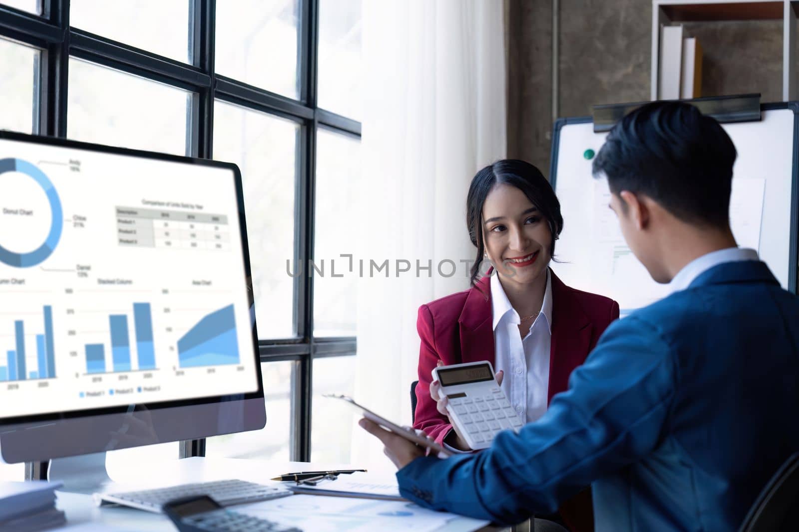 Young Asian business team creative businesspeople coworker in office. Meeting Presentation for tax analysis graph company financial. People Work in Business Office.