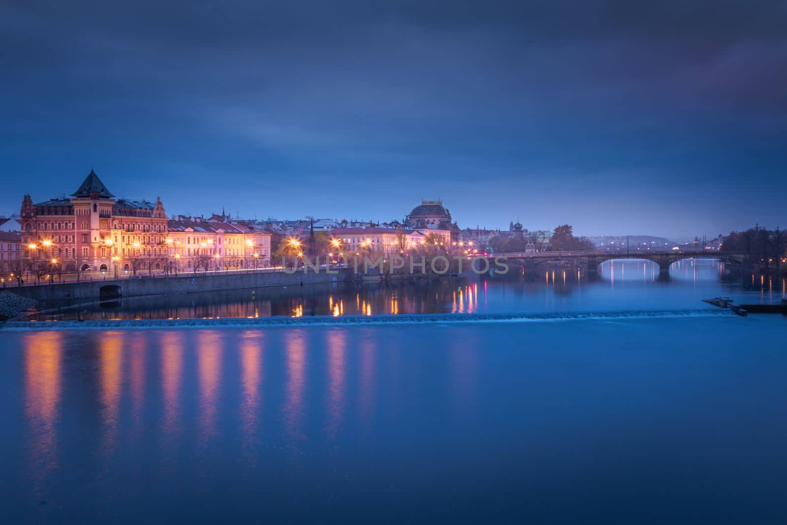 Panoramic view over the cityscape of Prague and Vltava river at dramatic evening, Czech Republic