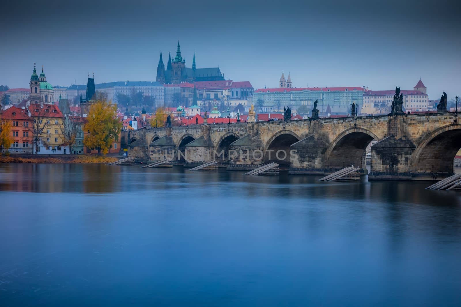 Panoramic view over the cityscape of Prague and Vltava river at dramatic evening, Czech Republic