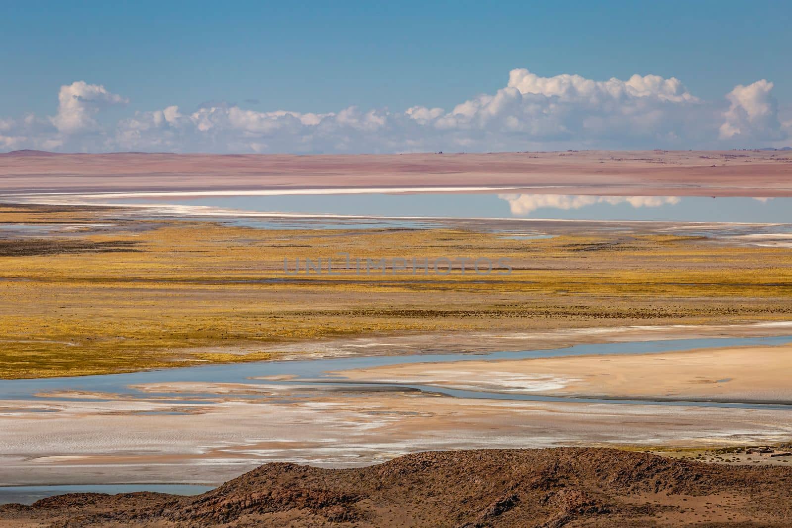 Salt lake reflection and idyllic volcanic landscape at Sunset, Atacama desert, Chile border with Bolivia