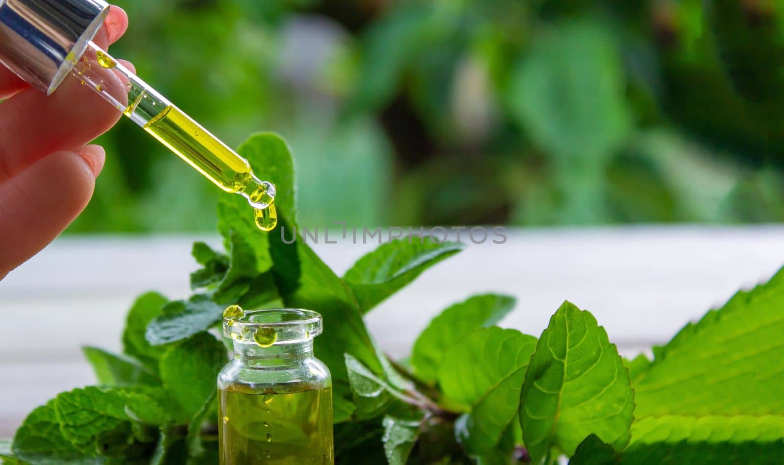 The mint extract in a small jar. Selective focus.