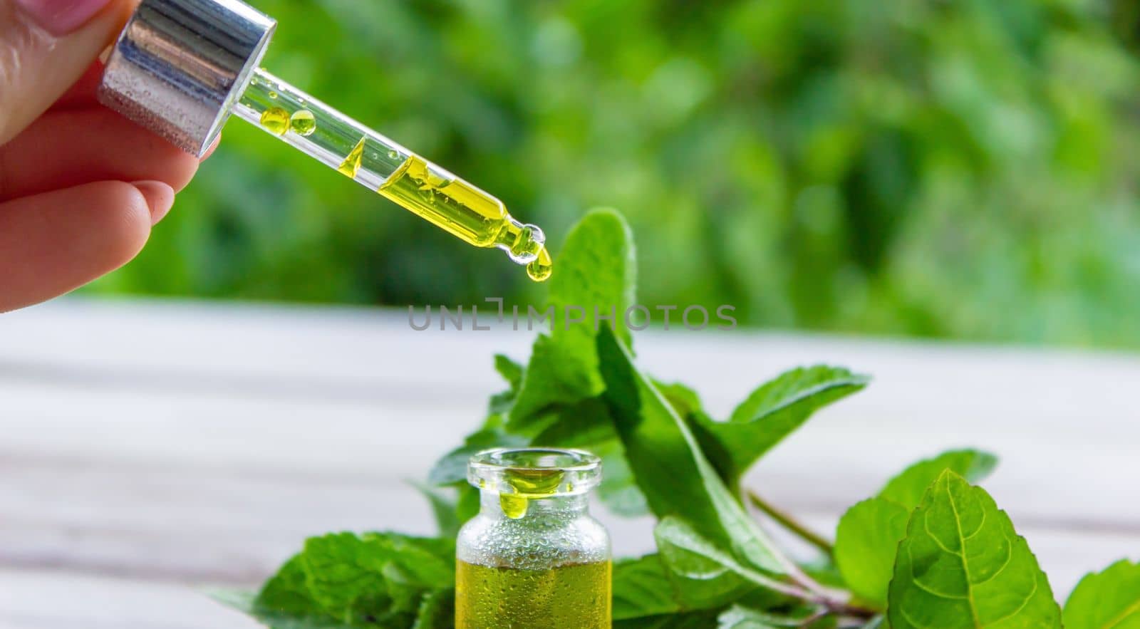 The mint extract in a small jar. Selective focus.